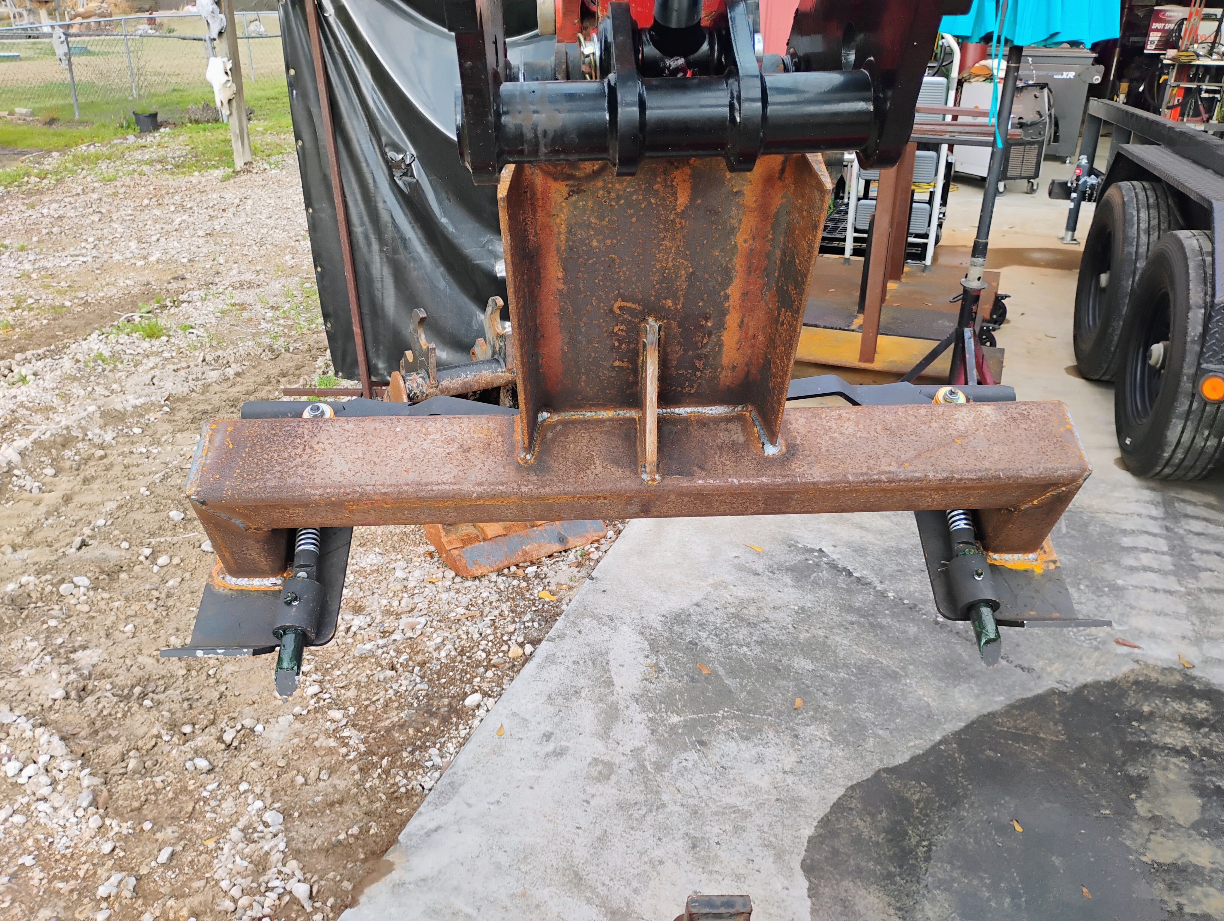 Back view of custom excavator brush cutter mount and support hardware