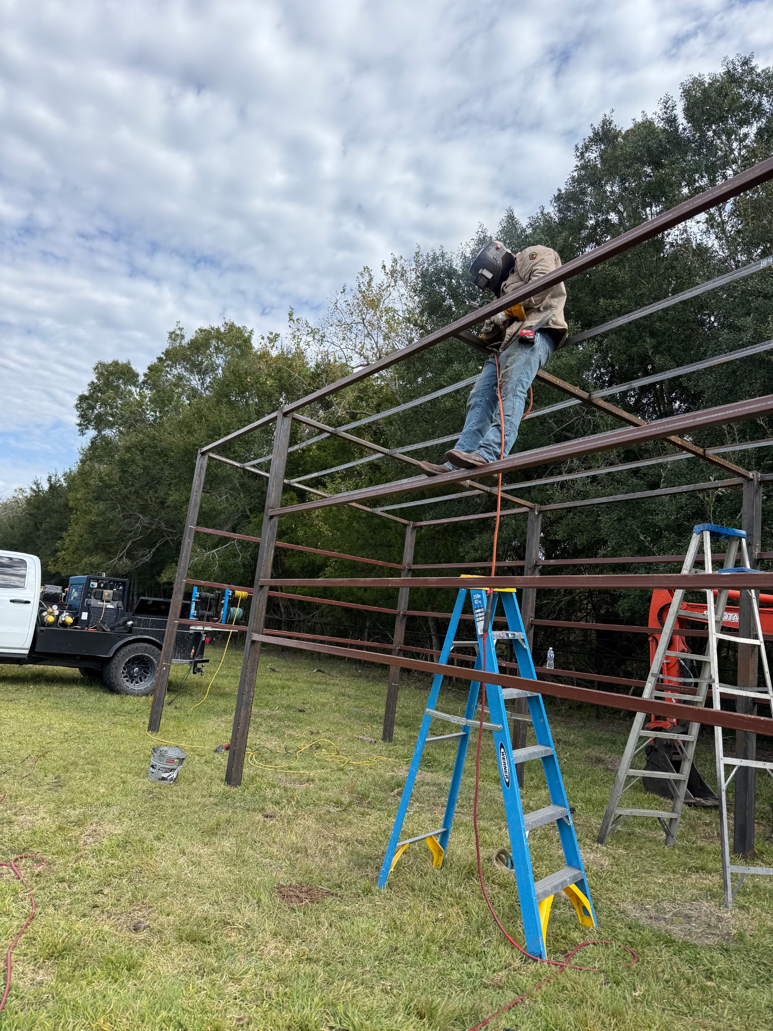 Livestock shelter frame welding in field